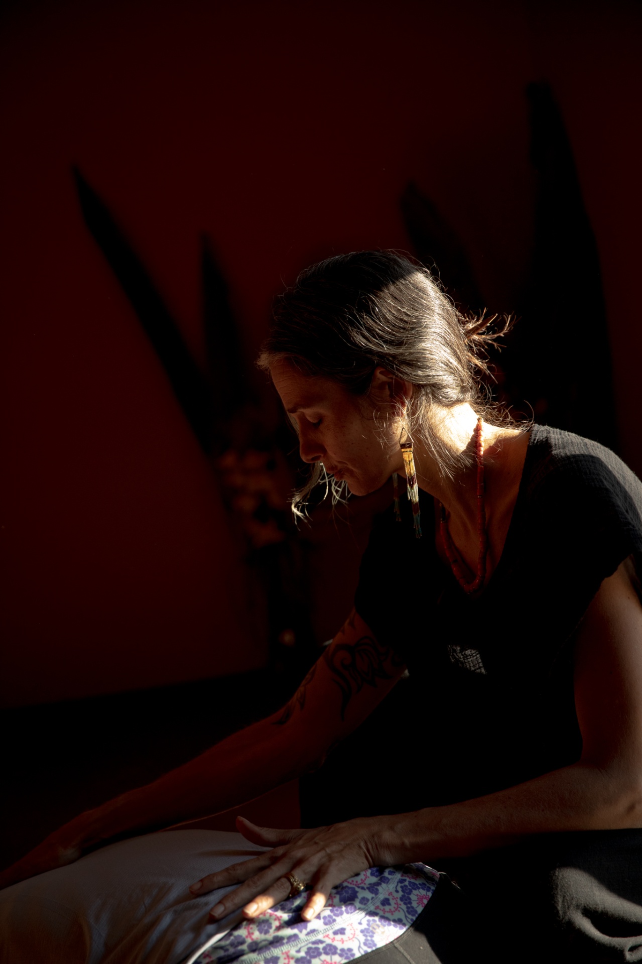 Adya holding a one-on-one session in warm low light