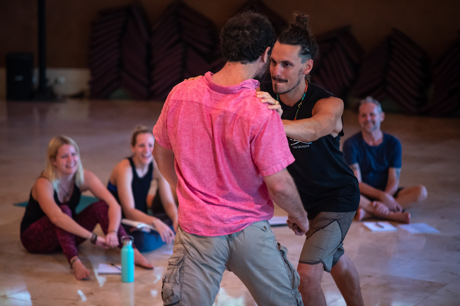 Velan working hands-on with a partner in a movement session