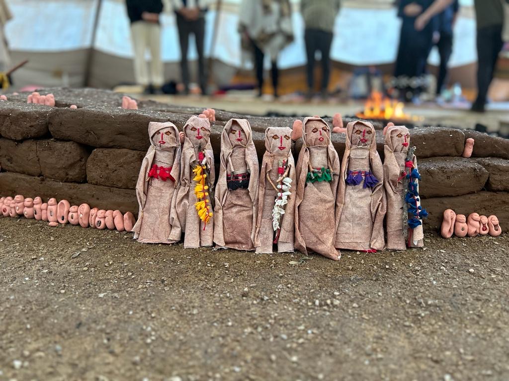 Ceremonial figures by the fire