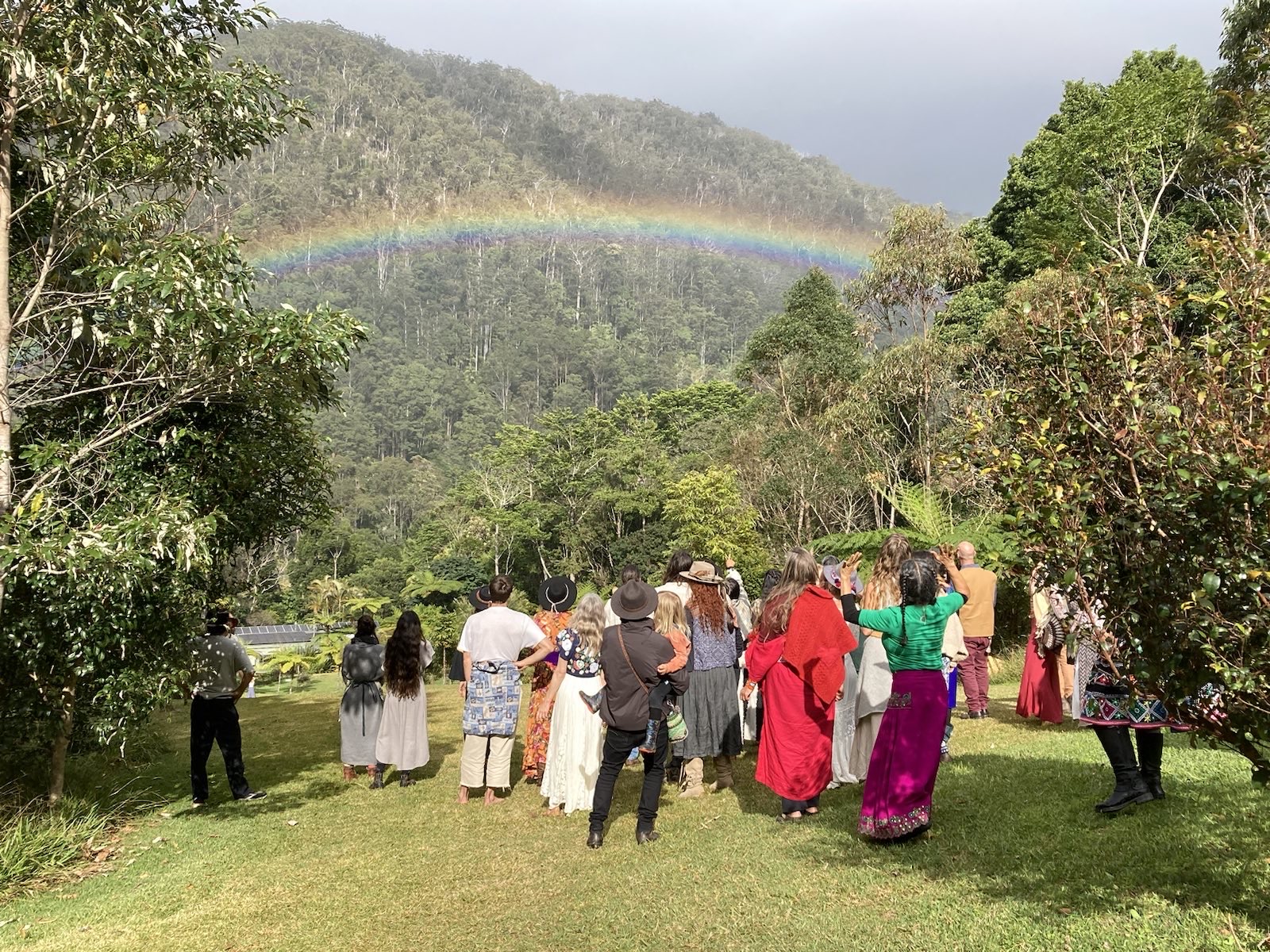 Circle in the forest beneath a rainbow